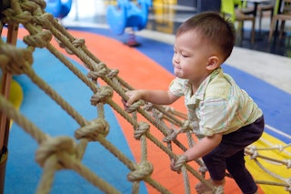 child on ropes being active