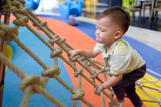 child on ropes being active