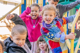 Kids Smiling on Playset at School