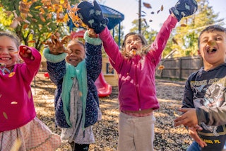 Kids Throwing Leaves on Playground