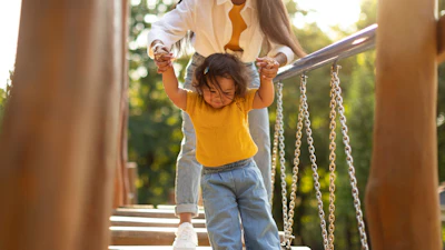 Mom and toddler on swinging bridge