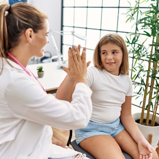 Health Care Provider high five with Child
