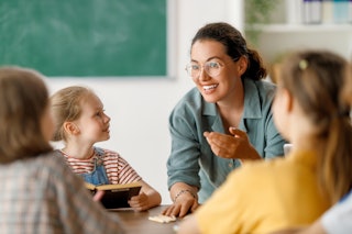 Teacher with young children at table